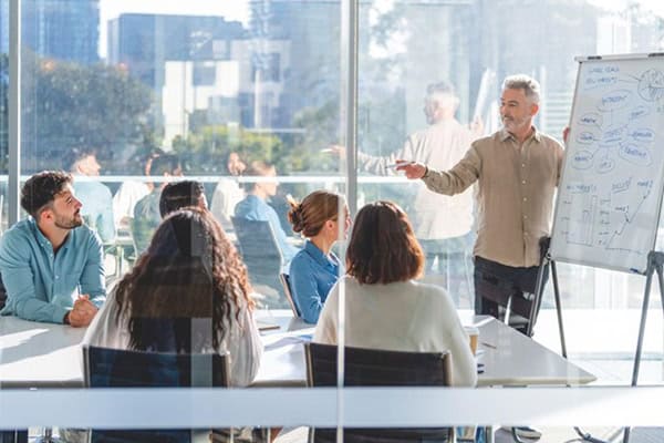 A staff training session taking place in an office conference room.