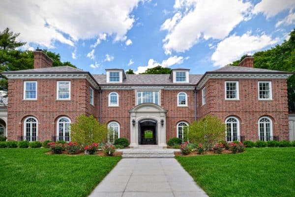 red brick house paired with multi-colored roof for a hip and quirky look