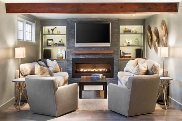 small but charming- a cozy basement room with linear fireplace, tv above, and built-in shelves