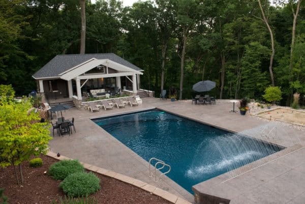 make your backyard fancy with stunning water feature and stamped concrete jumping deck