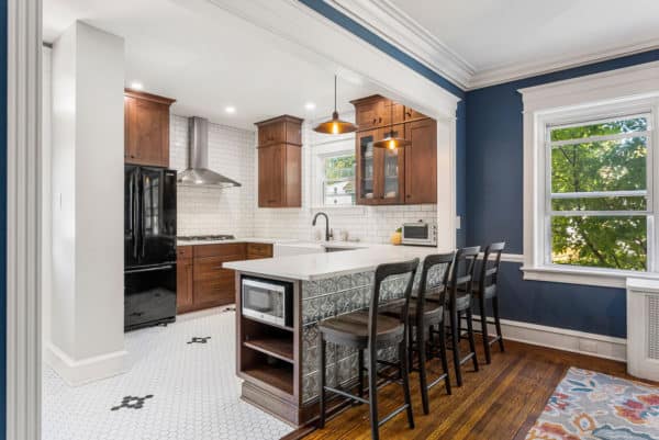 combine white porcelain tiles and natural wood cabinets for a charming traditional kitchen