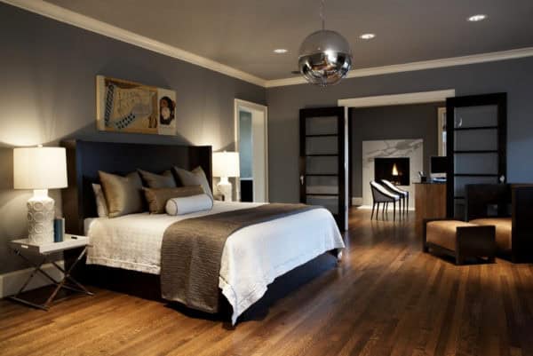 try a cozy bedroom nook with a black headboard, grey walls, and warm lighting