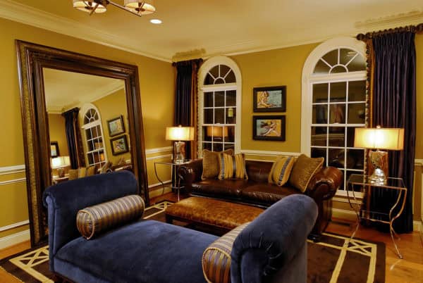 choose benjamin moore mystic gold hc-37 walls and blue fabric upholstery for a masculine living room