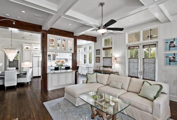 dark wood pillars and white cabinets make a luxurious half wall room divider