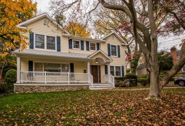 vinyl gable roof can complement a muted yellow house with dark blue shutters