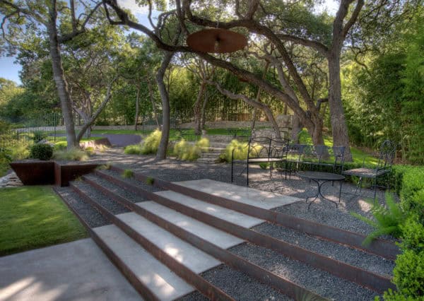 roadside landscaping makes use of rustic corten steel for the retaining walls