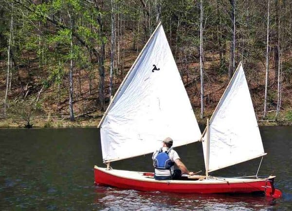 Chautauqua sailing canoe skin on frame sailing for the first time on a mountain lake. Main and Mizzen lug sails