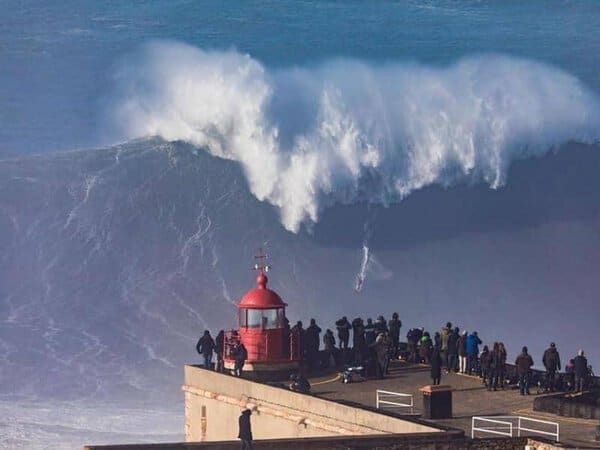 The red lighthouse against a background of gigantic waves