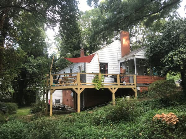 build a beautiful home featuring a rustic second-story deck with metal railing and siding