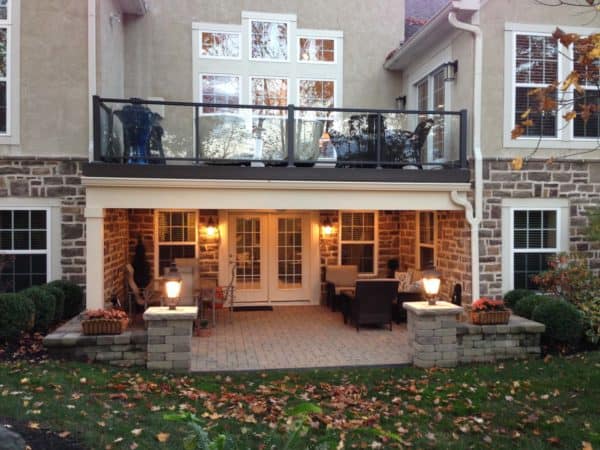 set up a comfy second-story deck over warm patio complete with glass railings