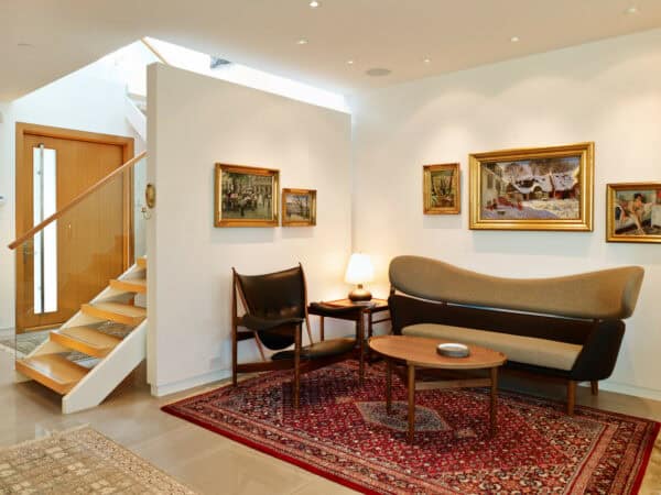 embrace the stunning mid-century living room vibe with a simple false wall to separate the staircase