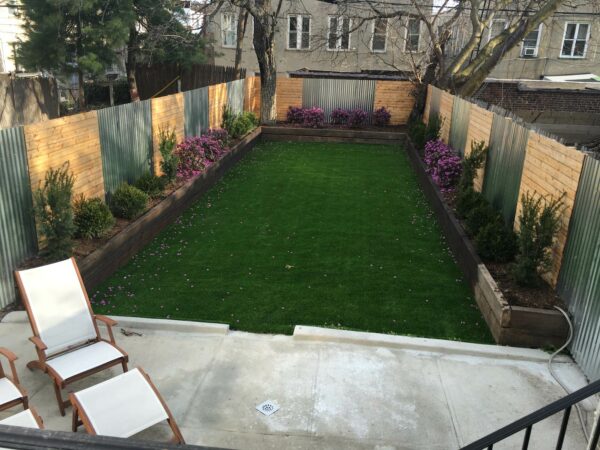 this spacious full sun backyard incorporates wood and metal walls for a gorgeous way to add privacy