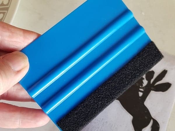 Squeegee tool to rub weeded vinyl to make it stay