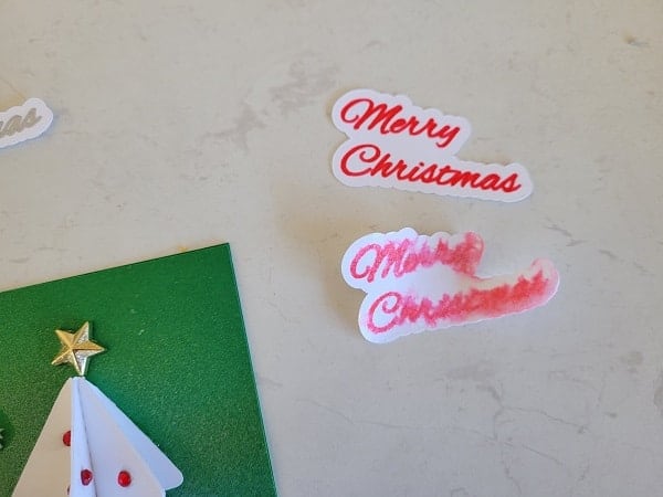 Error where I sprayed the Merry Christmas sentimentwith the Shimmer spray and the writing bled.