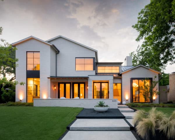 glass windows with aluminium black trim contrasted with white painted brick house