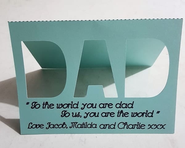 Cut out Father's Day card with DAD cut out and sentiment written on the front