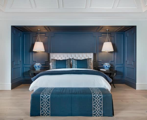 combine an alcove nook with wall paneling to style a classic and timeless royal blue bedroom