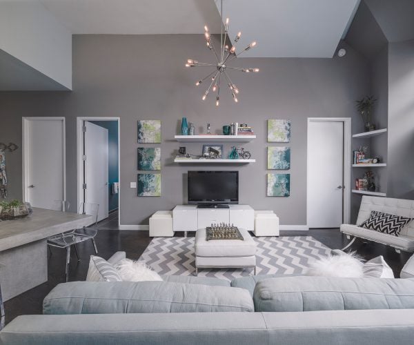 this contemporary living room with benjamin moore winter gates gray walls and white trim features a gorgeous pendant chandelier