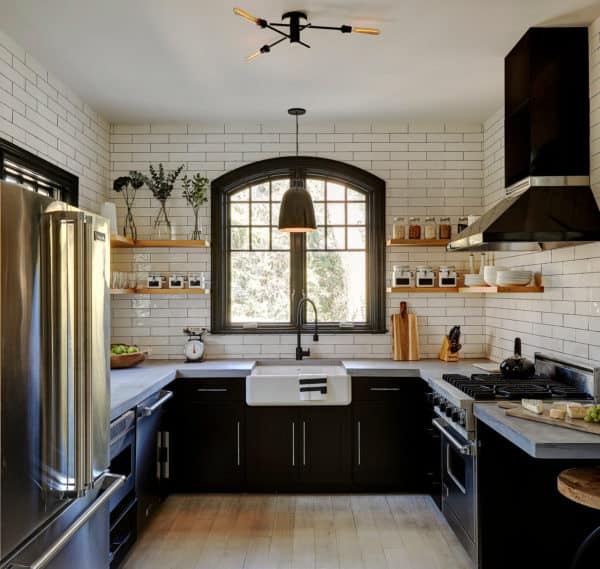 build a charming farmhouse kitchen using subway tile with black grout walls and stainless-steel appliances