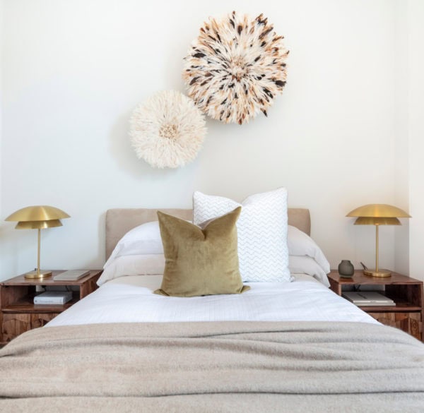 gold pillow and light fixtures with white walls for a contemporary bedroom