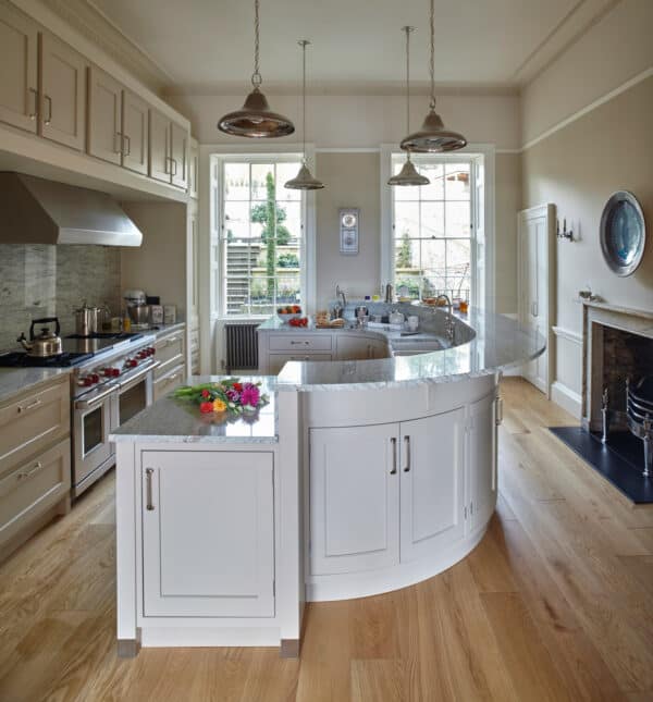 use river white granite countertops to make a galley kitchen with a curving island look more elegant