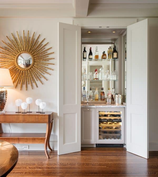 use a mirror backsplash behind your hidden small wet bar as a unique idea