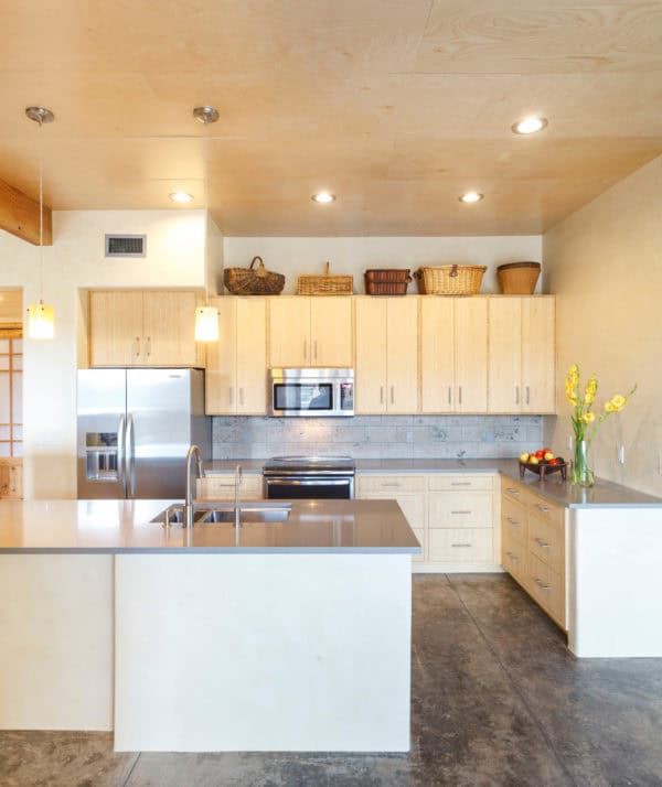 light brown cabinets look stylish with a grey backsplash in this southwestern kitchen