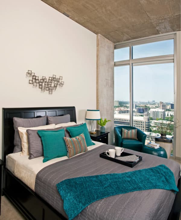 jazz up a black and grey bedroom with colorful accents and wall art