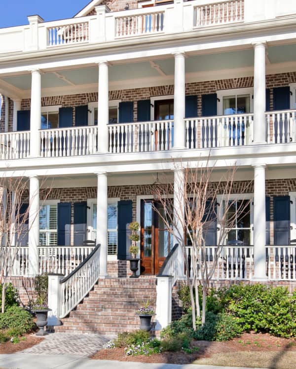 try the classy charleston green color for a window shutter in a grand brick home