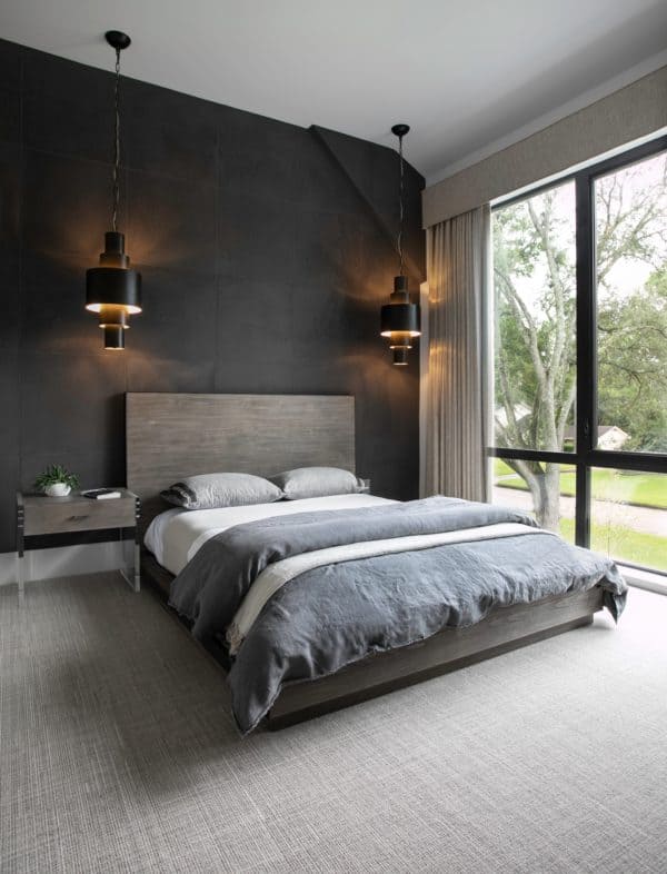 encapsulate contemporary elegance in the bedroom with black walls and grey carpet flooring