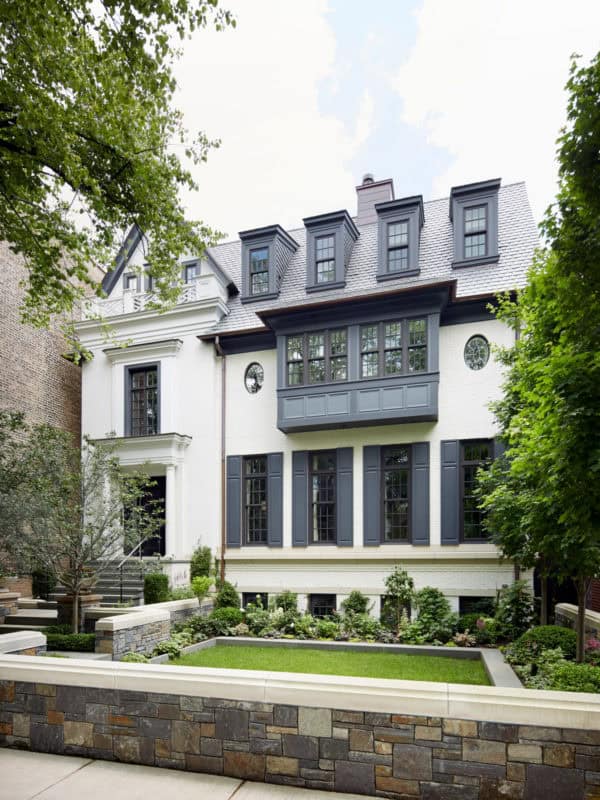 go for a dark shutter color to juxtapose the white exterior and create a stunning urban house