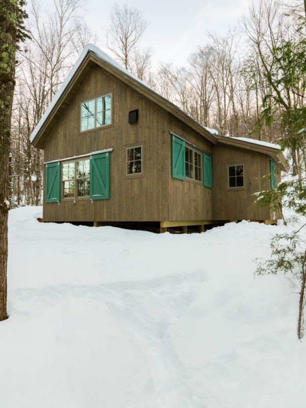 embellish a rustic mountain cabin with attractive forest green barn door window shutters