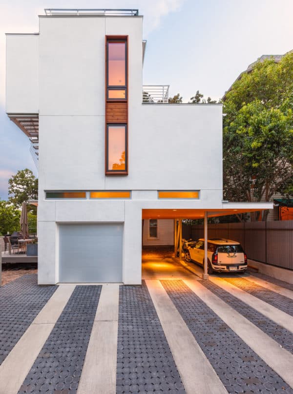 embrace contemporary architecture with this connected carport next to a lovely concrete house