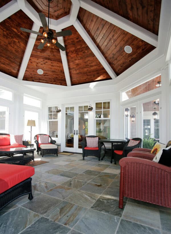 try a screened-in front porch with silver sands slate tile and a dramatic pine wood ceiling