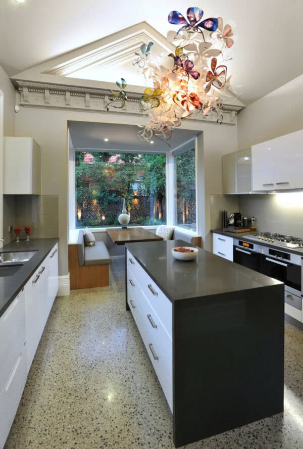 hang a colorful floral chandelier in your eat-in galley kitchen with an island for a fun and eye-catching feature