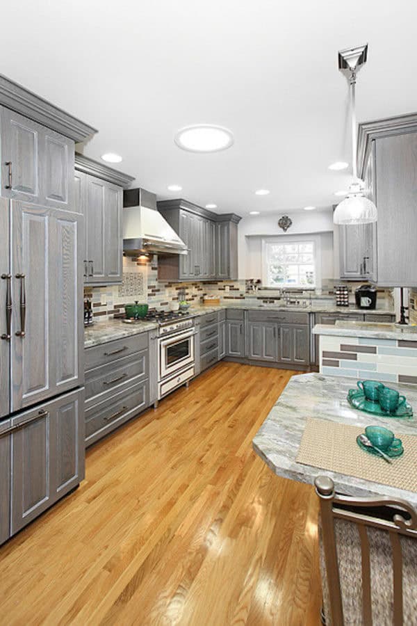 try grey-stained cabinets and rare granite countertops for an english cottage-inspired kitchen