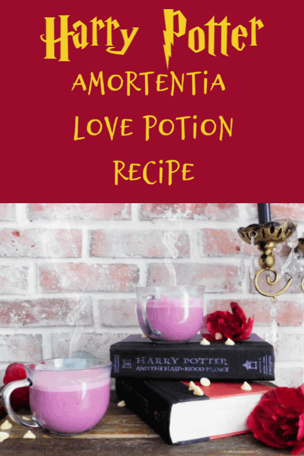 two cups full of pink amortentia potion on a table with books