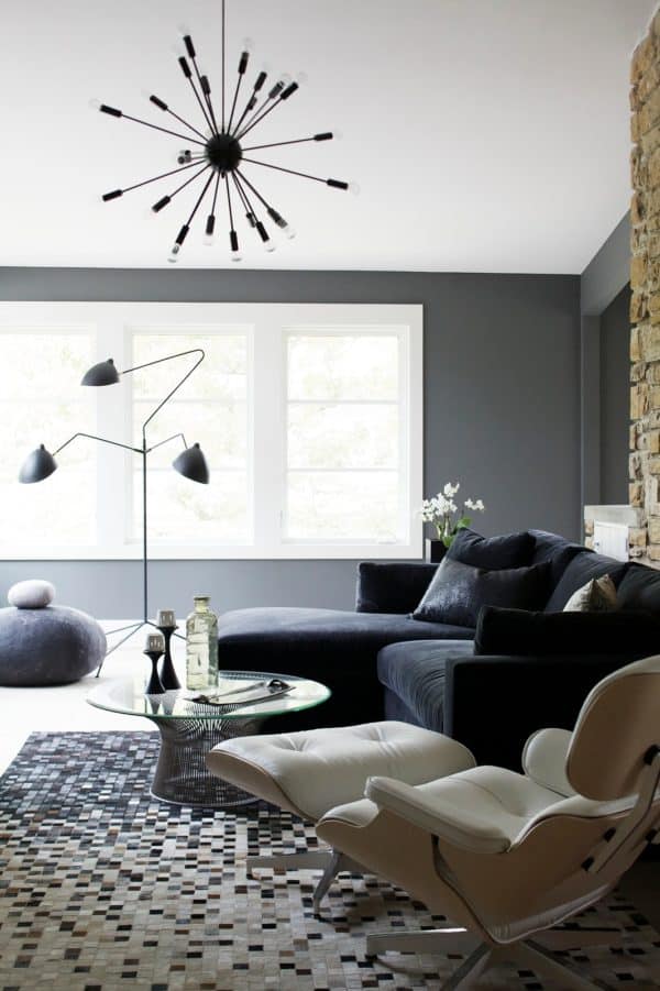 try a stainless-steel chandelier to decorate a modern white and gray living room with mid-century roots