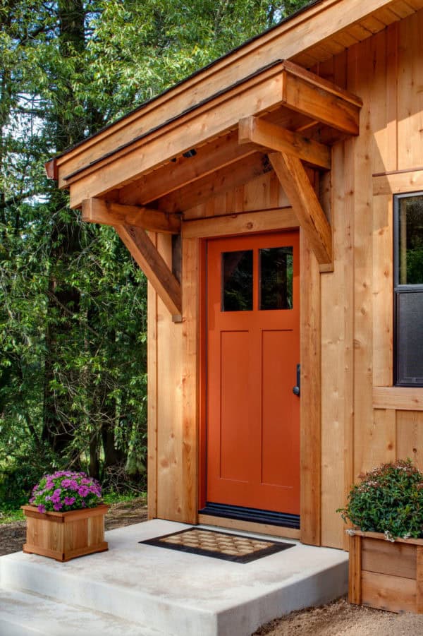 opt for all wood in this classic barn style entry with a slanted roof over the front door