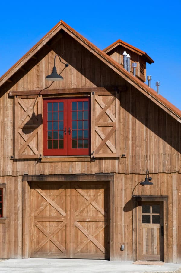 try custom wood window shutters to match the front door for a rural-inspired barn house