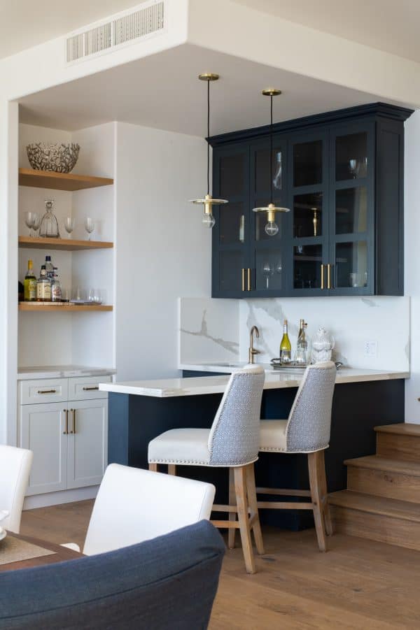 this simple and small wet bar with beach vibes near the stairs will help you save space