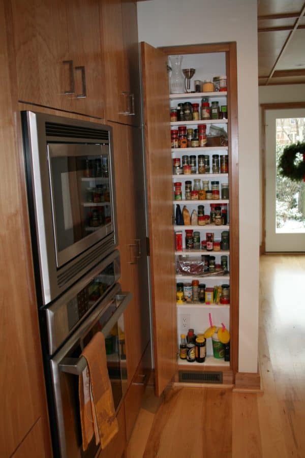 use wood for a recessed wall spice cabinet between studs to evoke a timeless interior ambiance