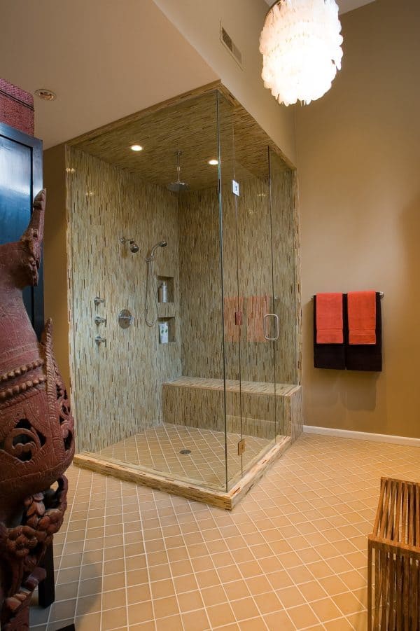 try creating a built-in shower shelf amidst beige matchstick tiles for an elegant contemporary bathroom