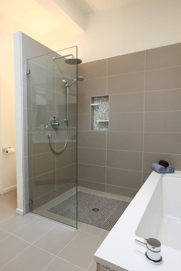 utilize leftover materials like caesarstone to embellish a small and stylish built-in shower shelf