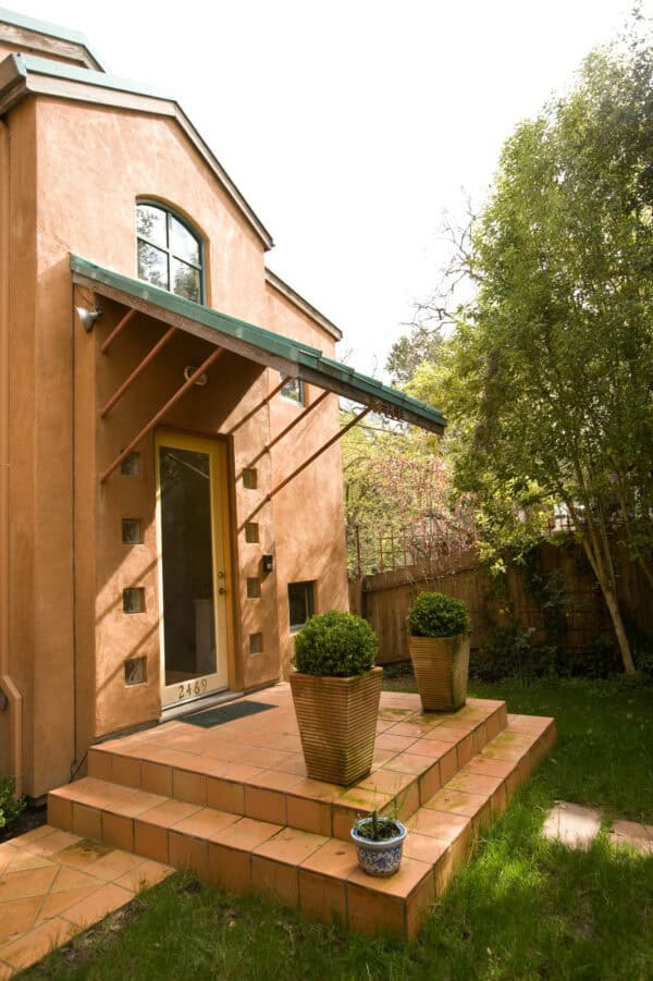 this mediterranean front porch rocks saltillo tile flooring and a small canopy