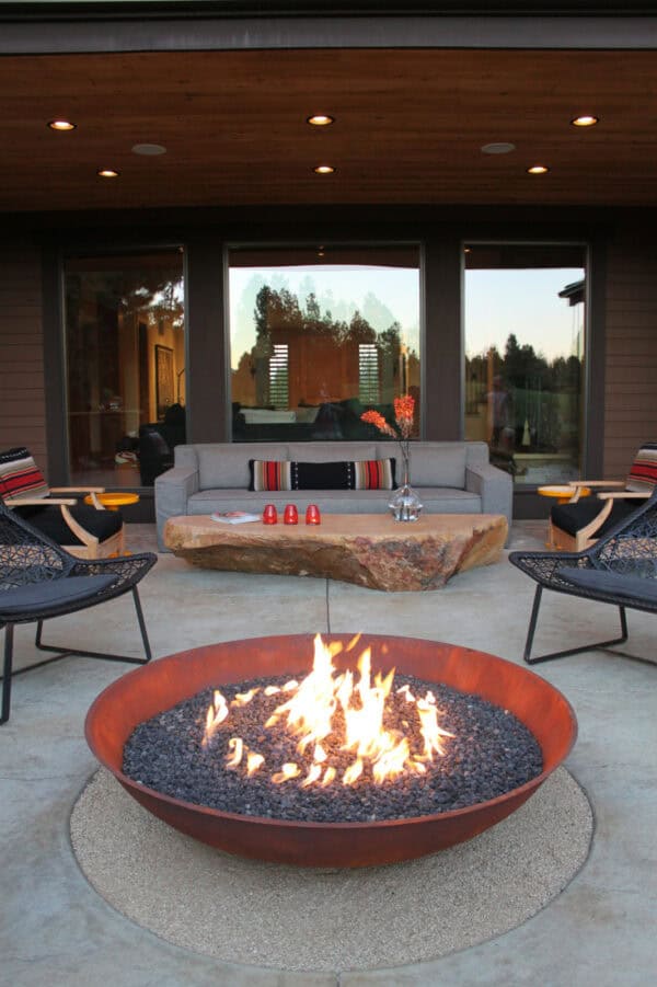 furnish a stamped concrete patio with a custom fire pit and crushed granite and rustic rock table