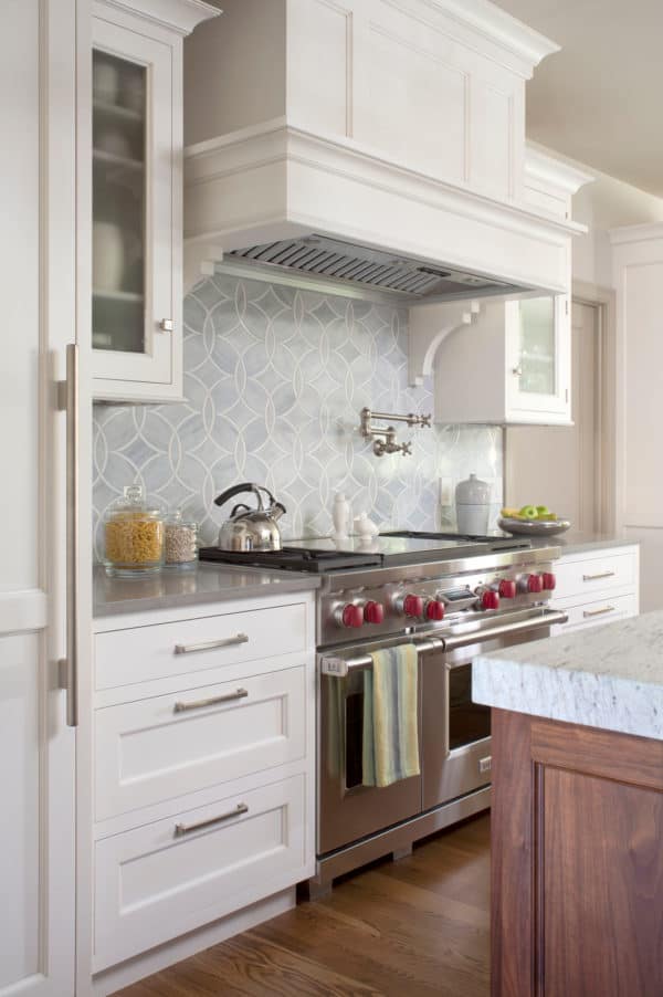 this classic bright farmhouse uses stainless appliances to complement white cabinets