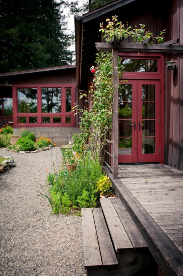 complete a glass-paned red front door with overflowing greeneries to create a calming sanctuary