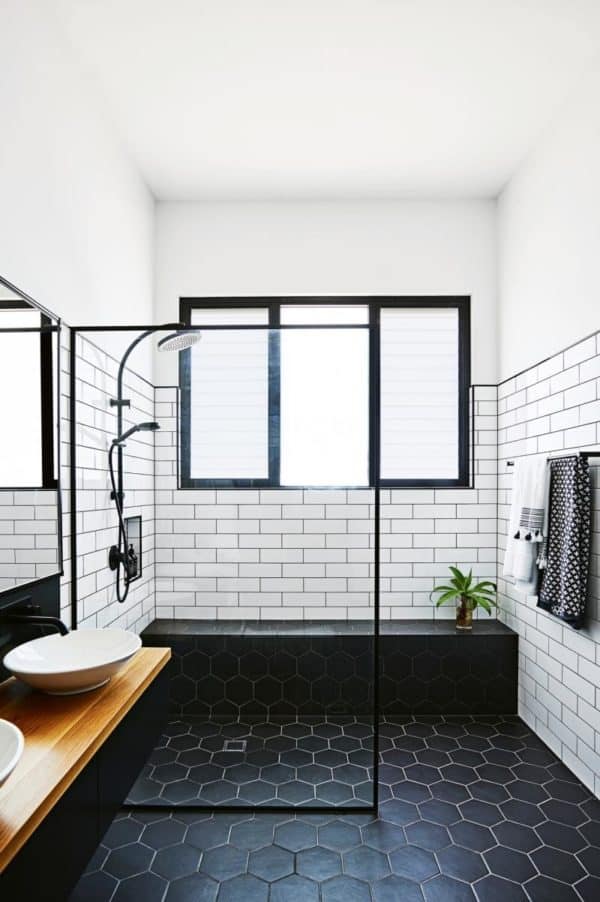 complete a contemporary bathroom with subway tile and black grout for shower walls with a wood floating vanity