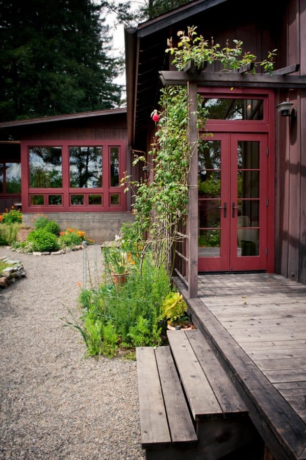 this simple maroon french door with transom completes the rustic mountain style home